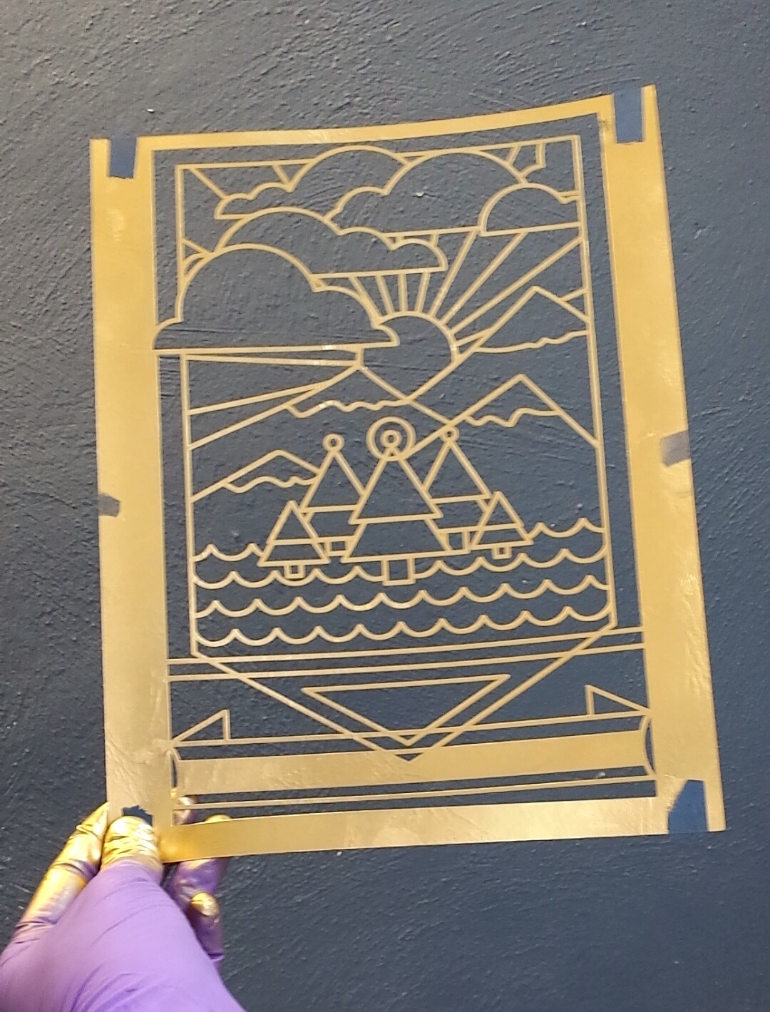 Laser cut poster held up after stencilling